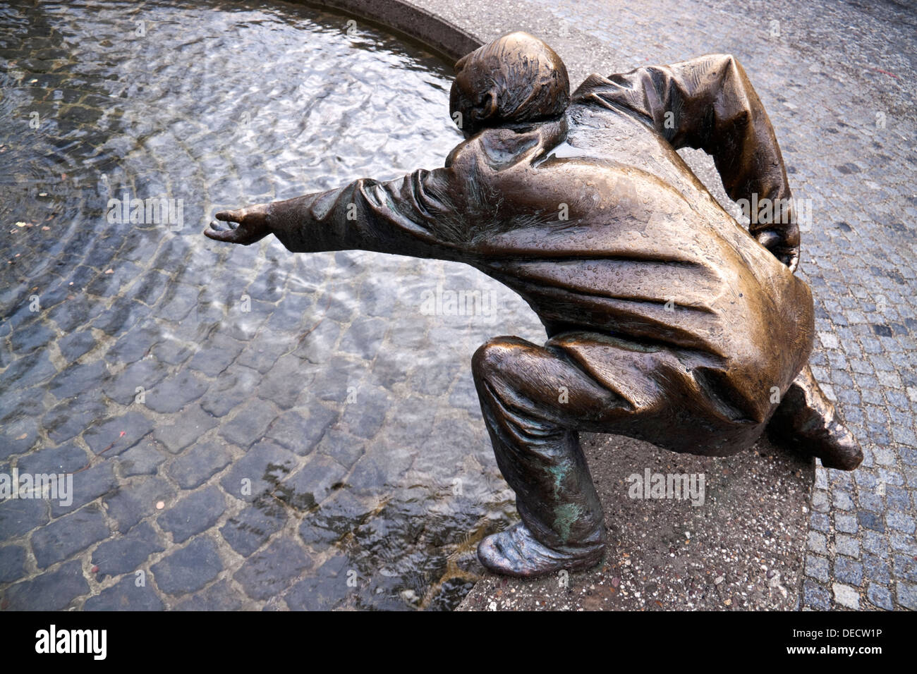 Bronze statue of a man begging in Aachen, Germany by Karl-Henning Seemann Stock Photo
