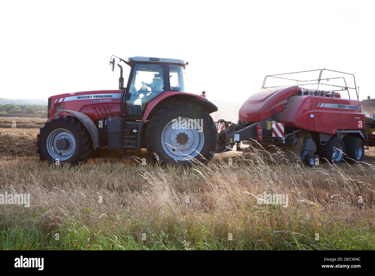 A Red Massey Ferguson Tractor And Baler Baling Straw In Open Countryside Stock Photo Alamy