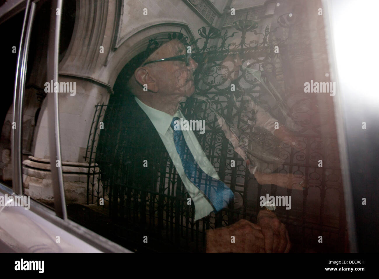 Rupert Murdoch, with his wife Wendi, is driven away after giving