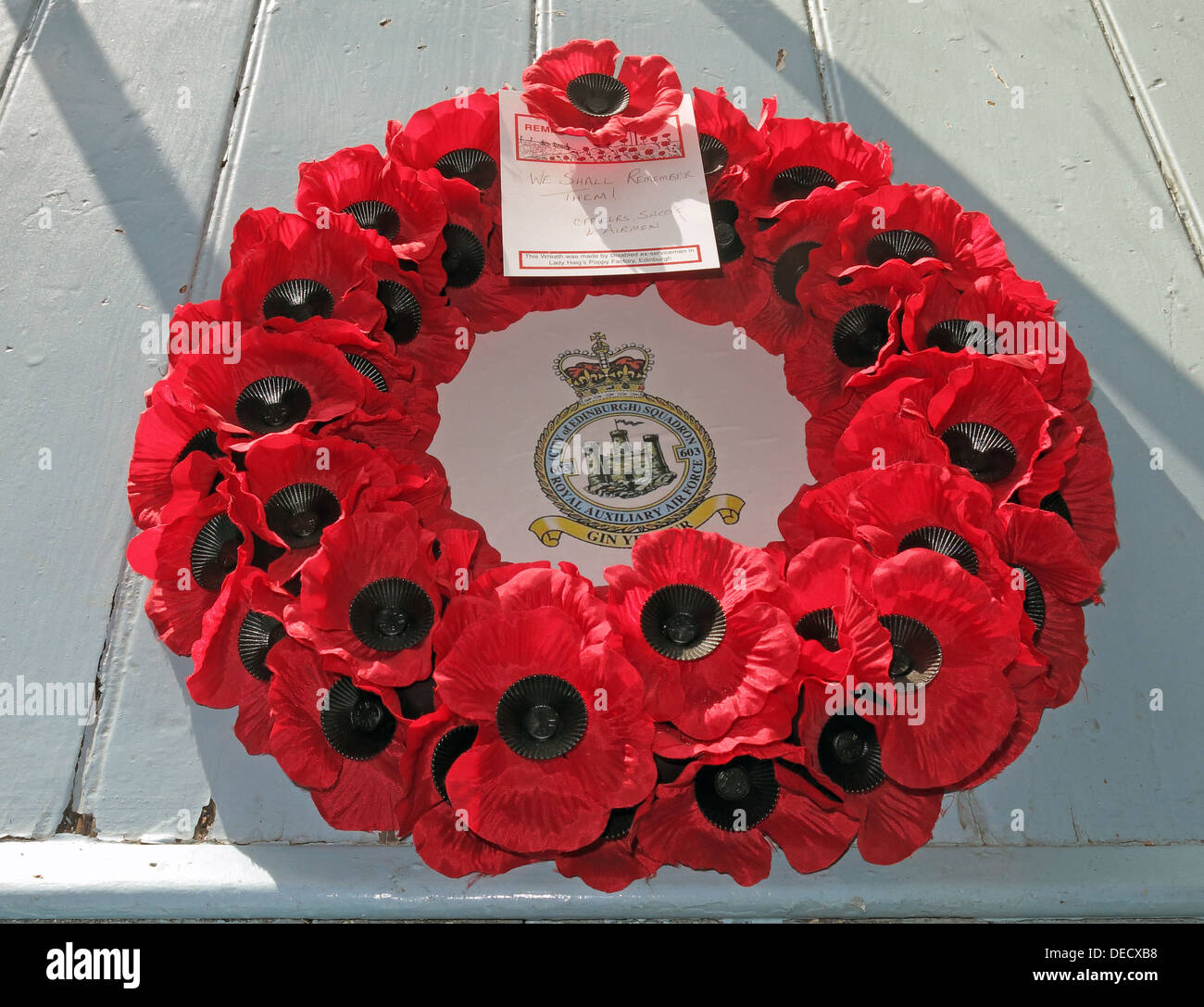 Red poppy wreath rememberance day Royal Auxiliary Air Force City of Edinburgh Squadron 603 at Canongate Kirk Stock Photo
