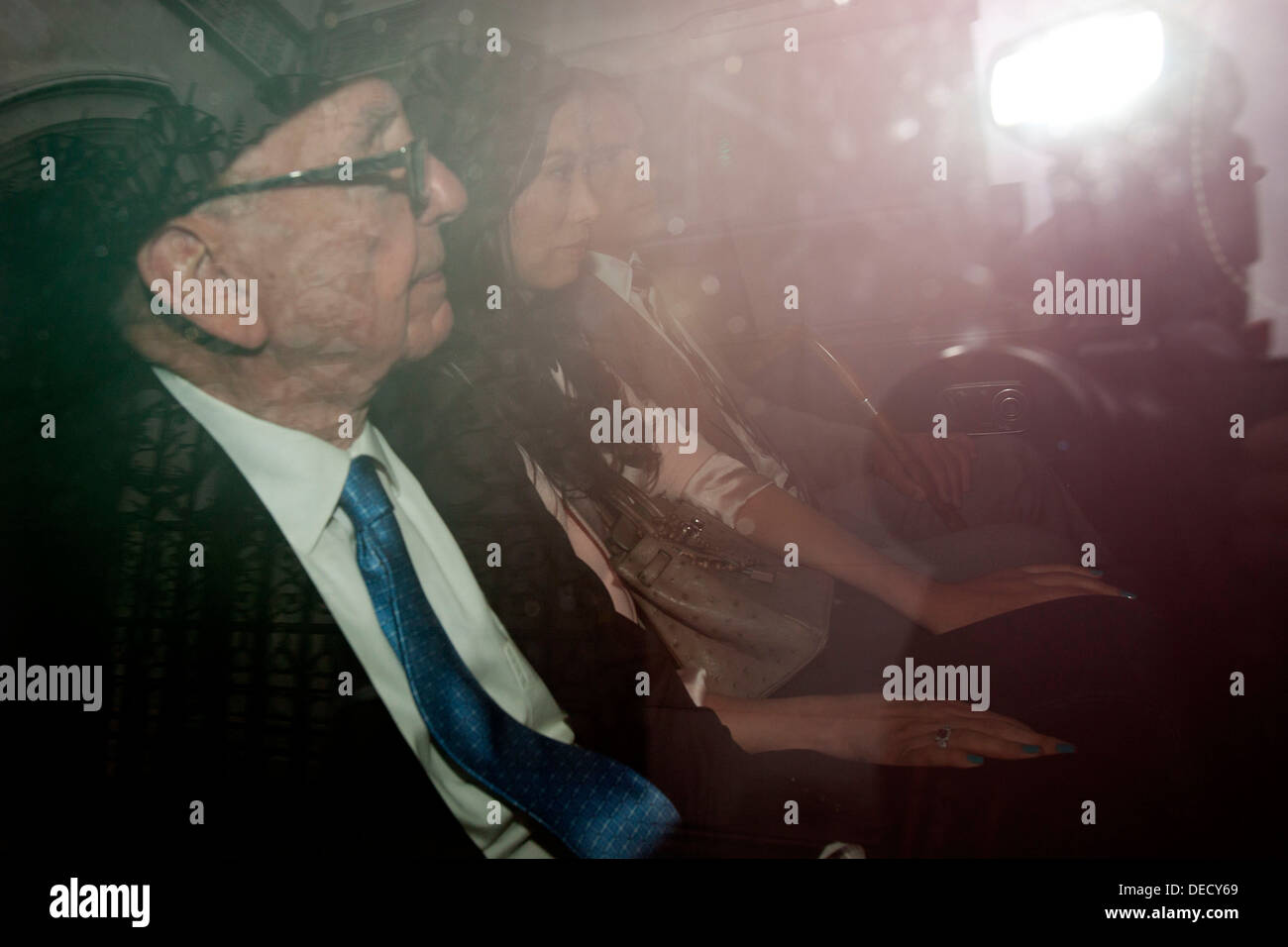 Rupert Murdoch, with his wife Wendi, is driven away after giving