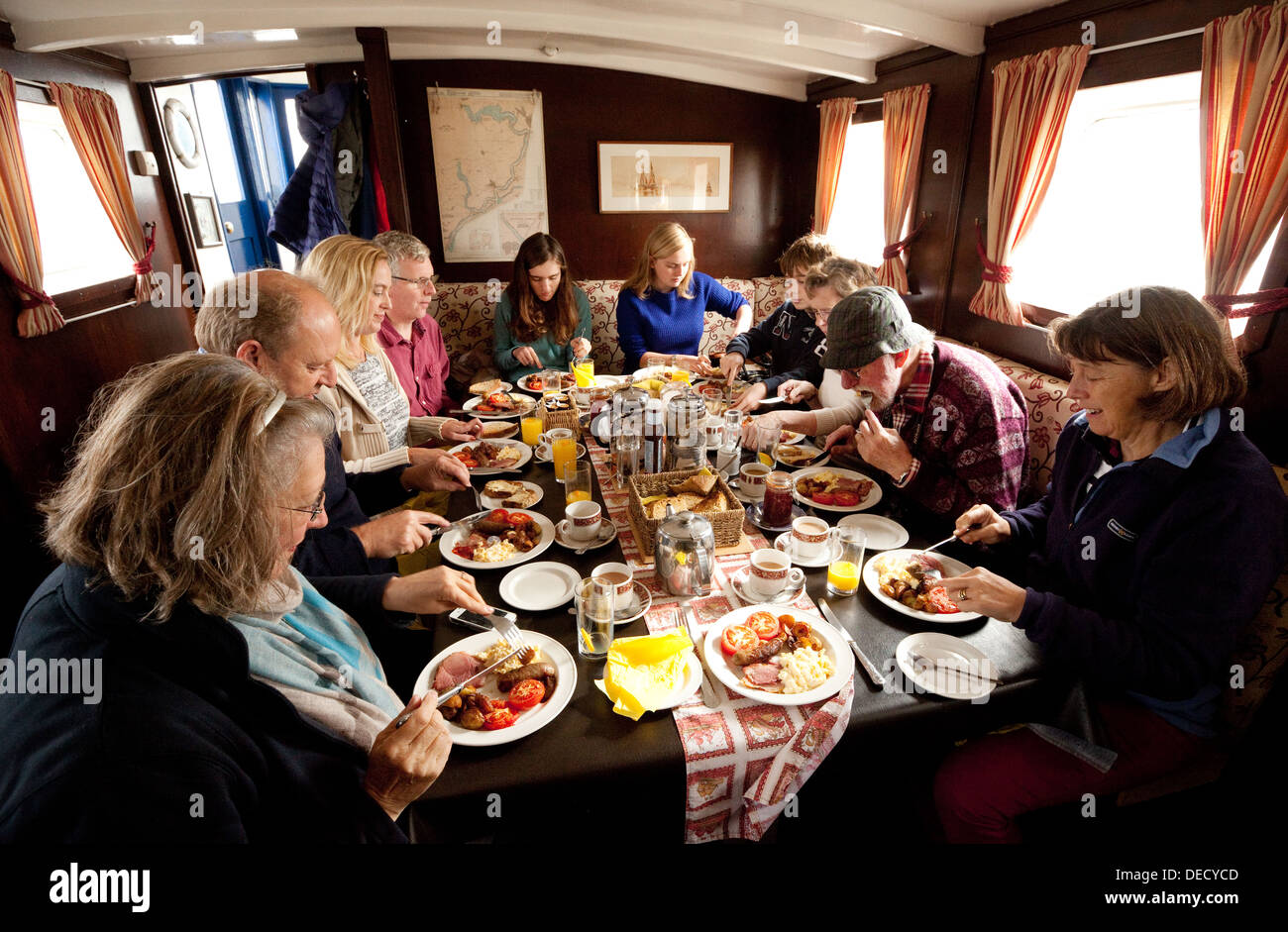 A group of people eating breakfast on a boat, The Lady Florence Stock