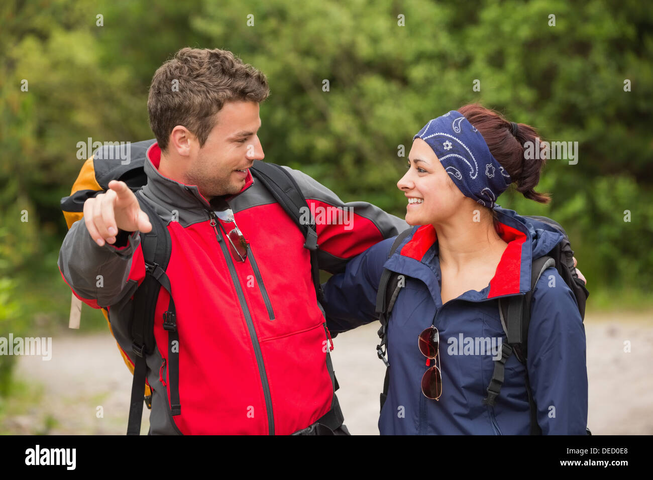 Smiling couple going on a hike together looking at each other Stock Photo