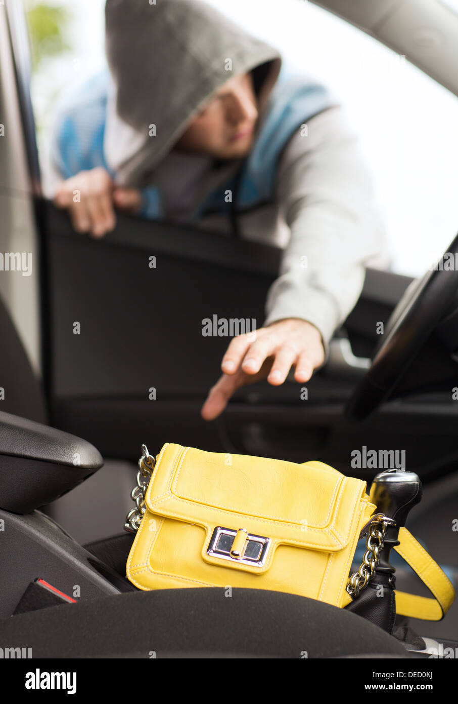 thief stealing bag from the car Stock Photo