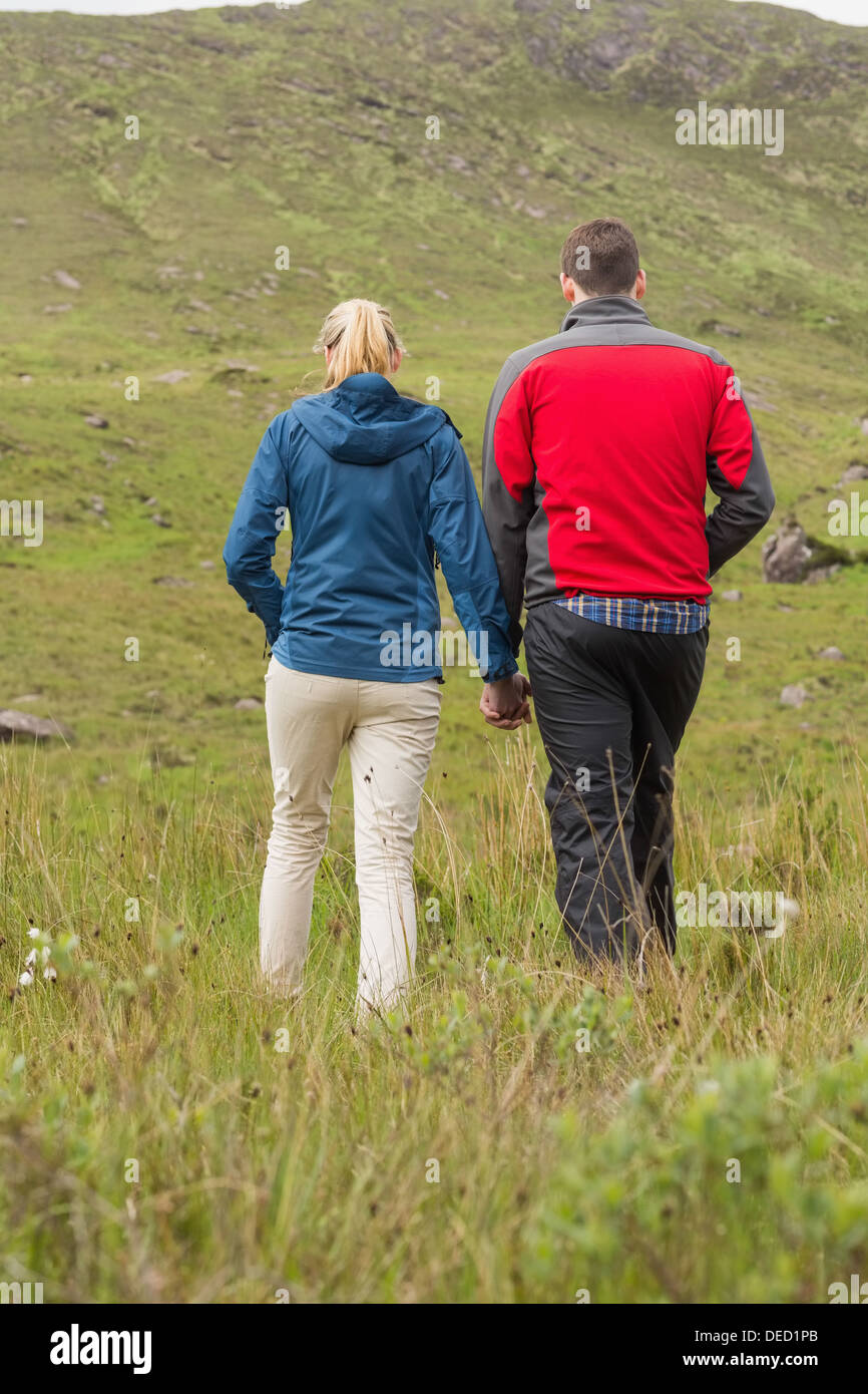 Couple holding hands and walking Stock Photo