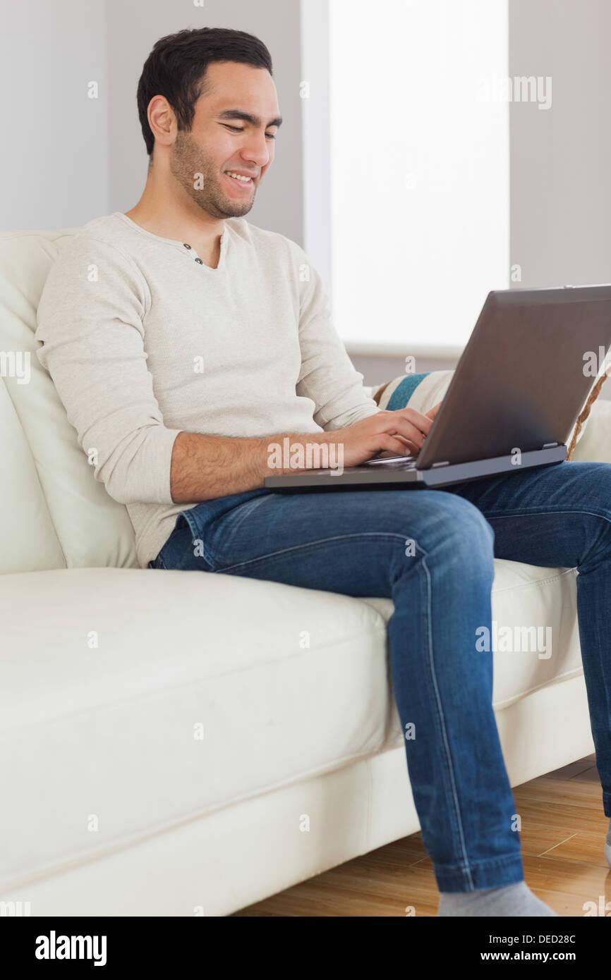 Smiling handsome man using his tablet computer Stock Photo
