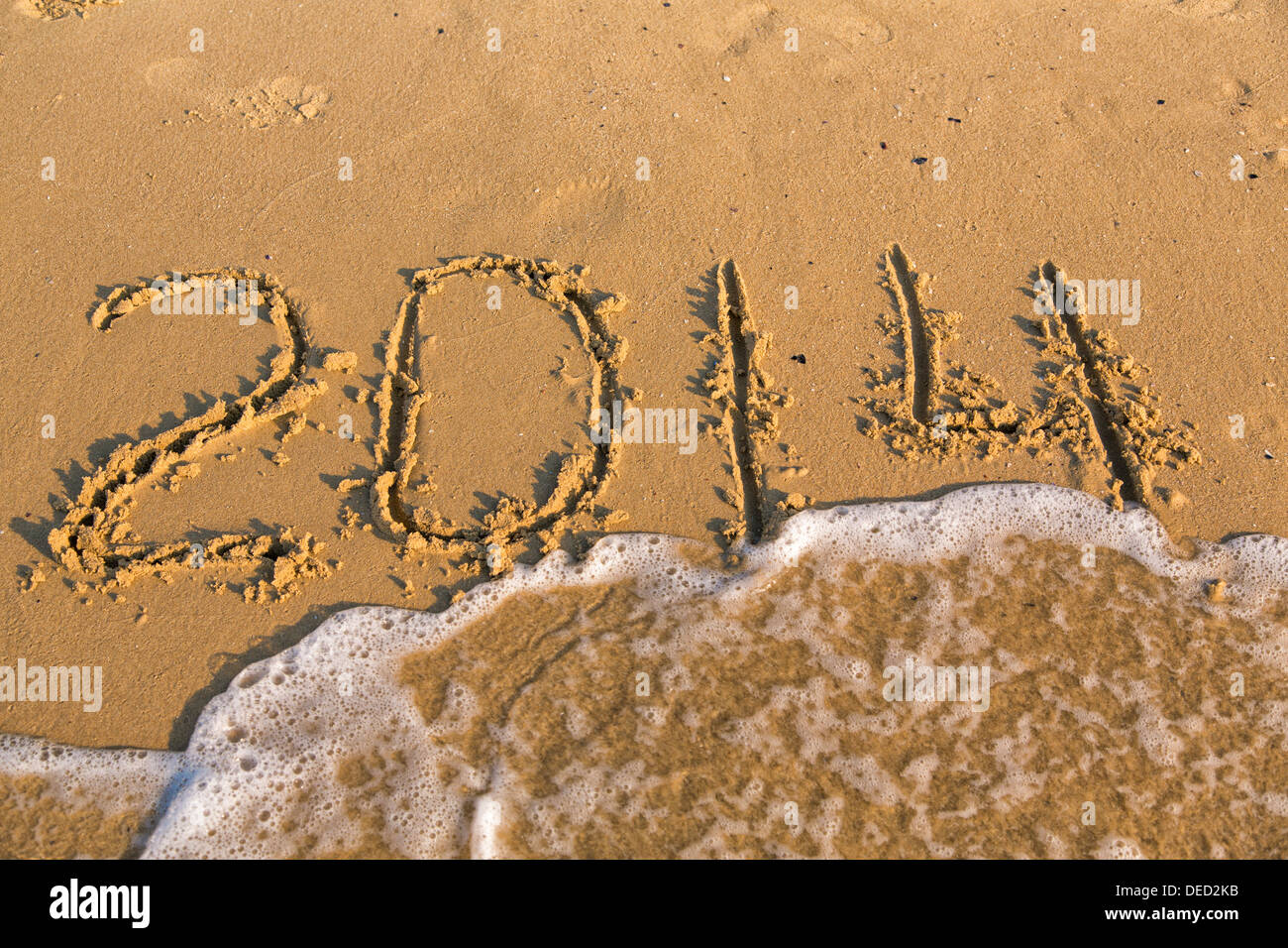 2014 numbers on the yellow sandy beach, text Stock Photo - Alamy