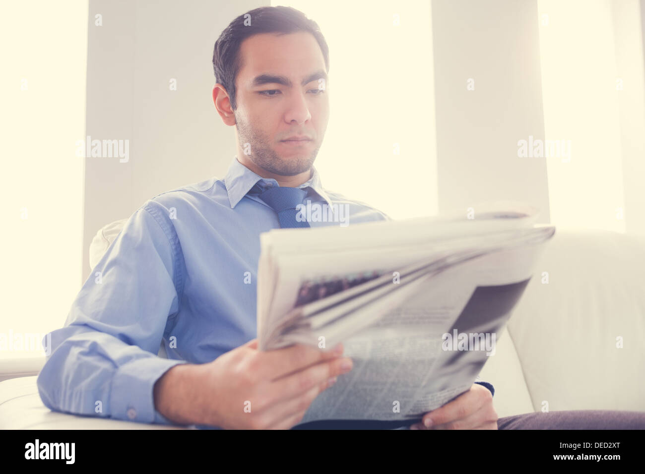 Handsome businessman reading newspaper Stock Photo