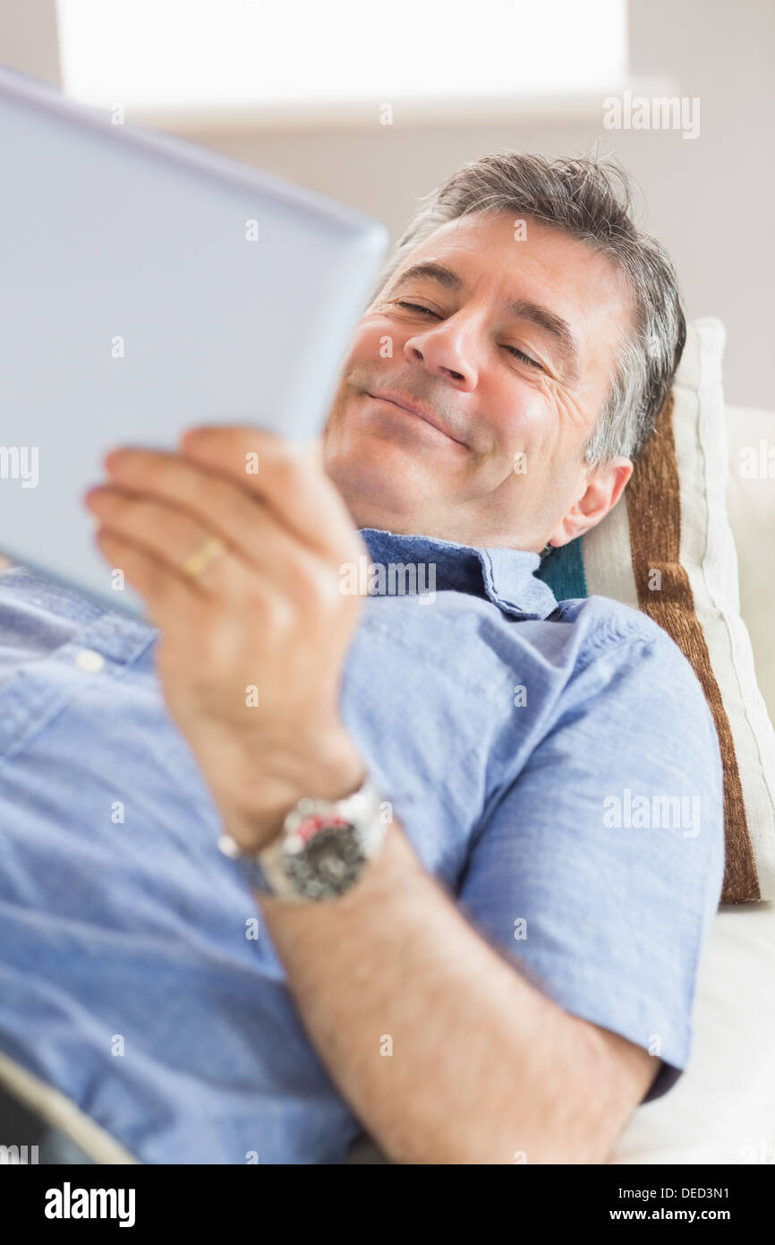 Happy man using a tablet pc Stock Photo