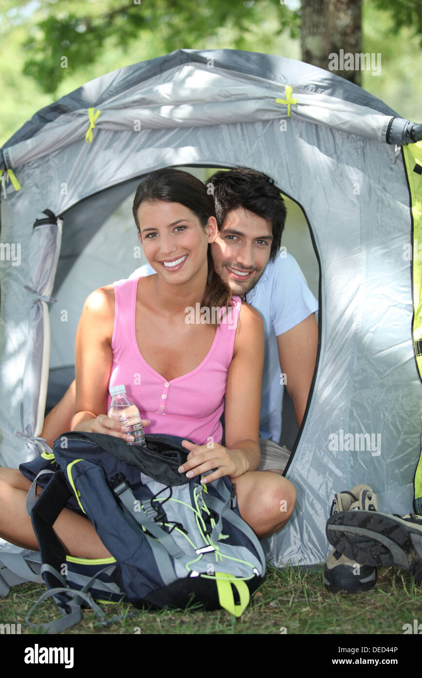 Couple sitting in front of their tent Stock Photo - Alamy