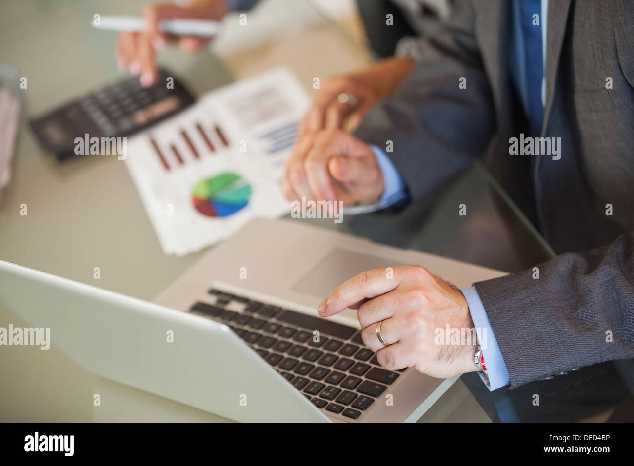 People in an office looking a laptop Stock Photo