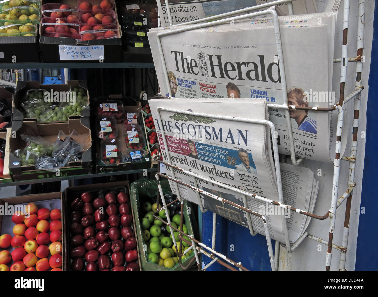 Local Newspapers on a stand Edinburgh Scotland at a grocers shop Stock Photo