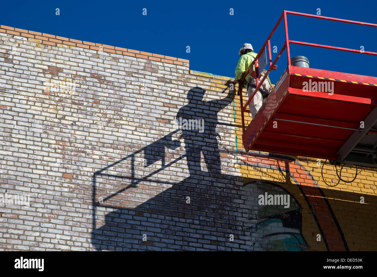 Detroit, Michigan - A worker repairs the painting on a wall at Eastern Market, the city's major farmers' market. Stock Photo