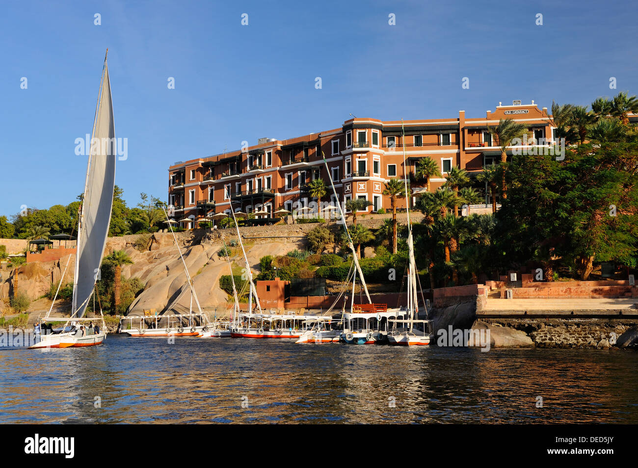 Felluccas on the River Nile beside the Old Cataract Hotel - Aswan, Upper Egypt Stock Photo