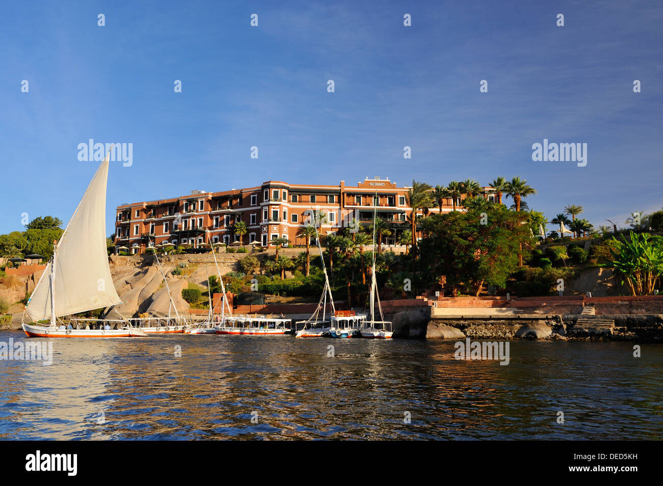 Felluccas on the River Nile beside the Old Cataract Hotel - Aswan, Upper Egypt Stock Photo