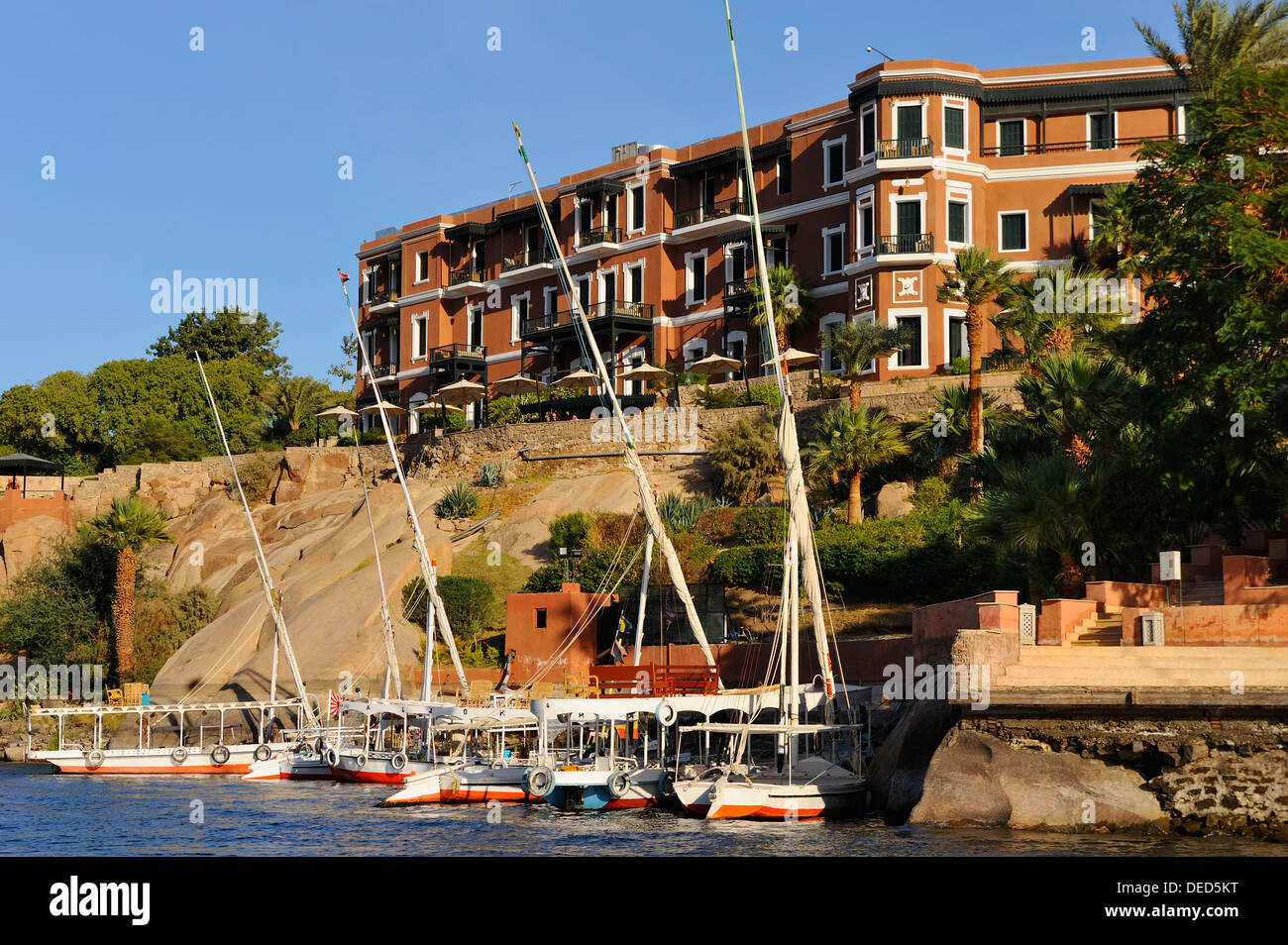 Felluccas on the River Nile beside the Old Cataract Hotel - Aswan, Upper Egypt Stock Photo