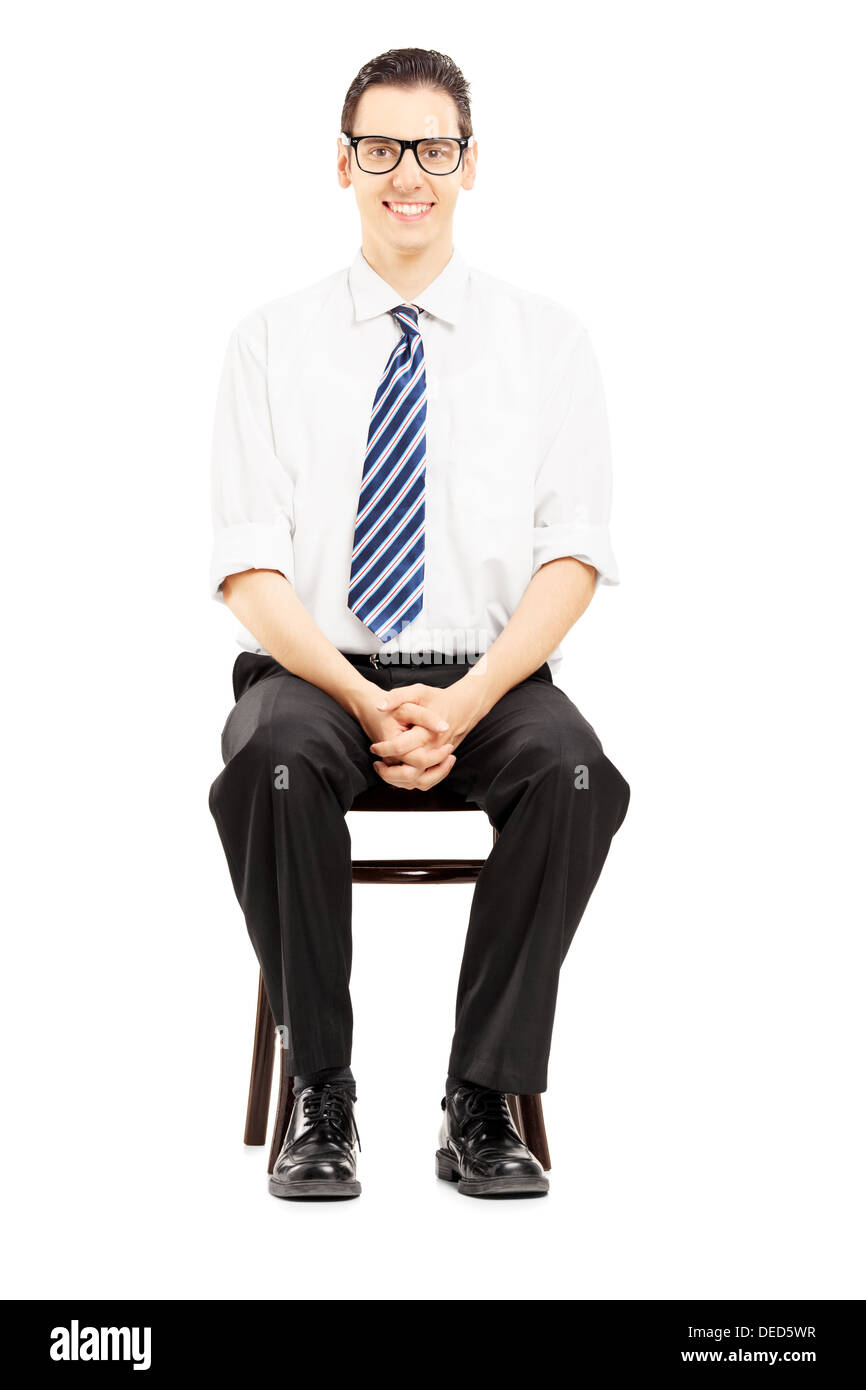 Young male with tie sitting on a wooden chair waiting for job interview Stock Photo