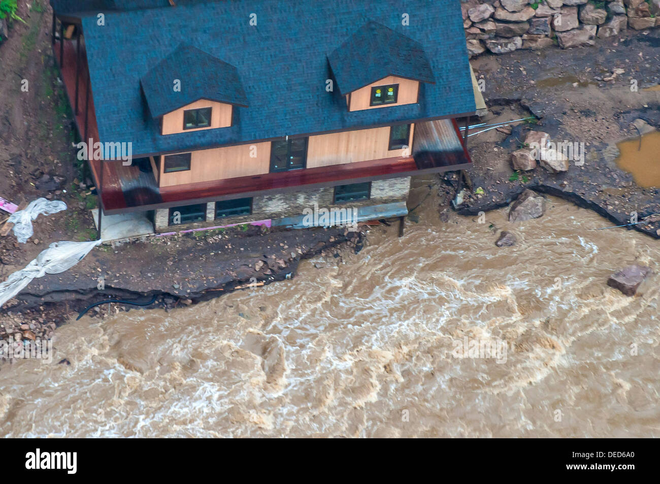 Aerial view of a home destroyed along the Big Thompson River in Northern Colorado washed out following severe flooding September 14, 2013 in Longmont, Colorado. Stock Photo