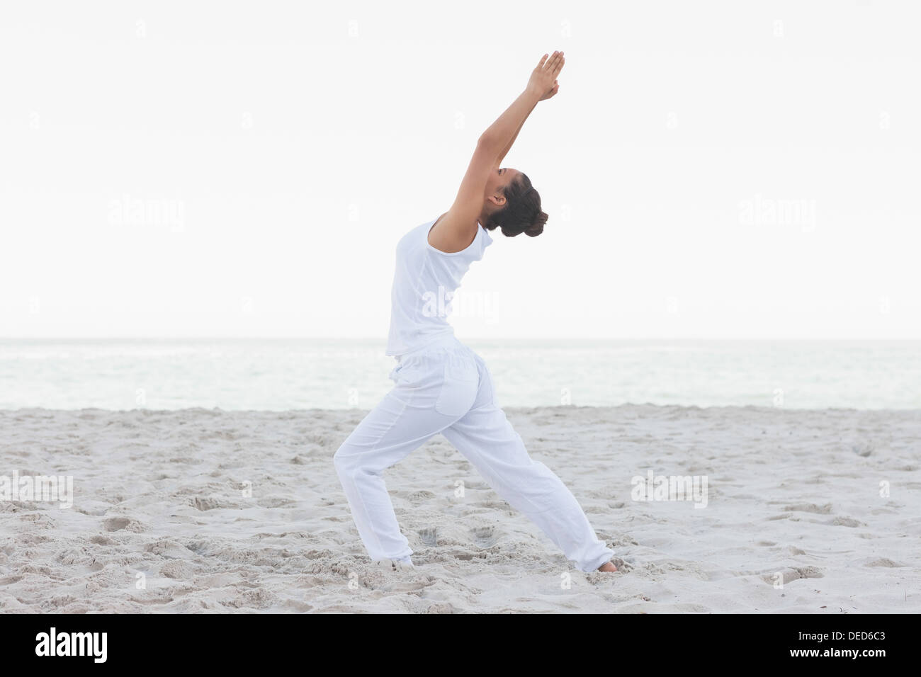 Woman in low lunge yoga pose Stock Photo - Alamy
