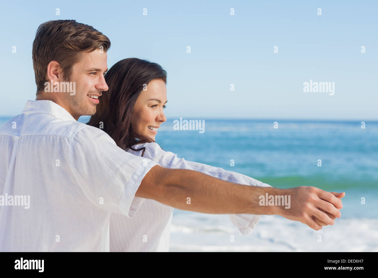Romantic couple relaxing on the beach Stock Photo - Alamy