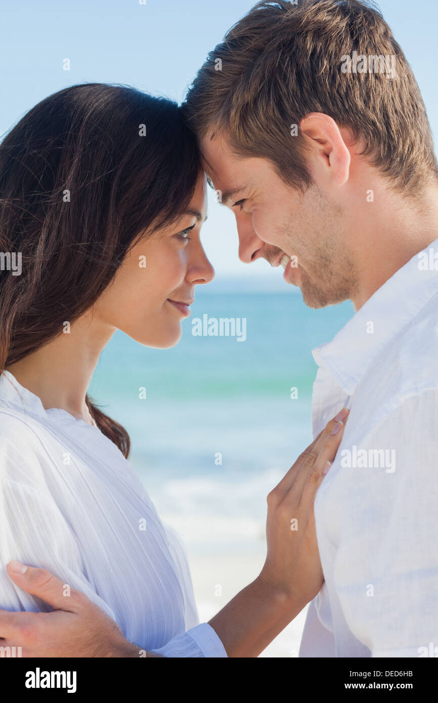 Romantic couple relaxing on the beach Stock Photo