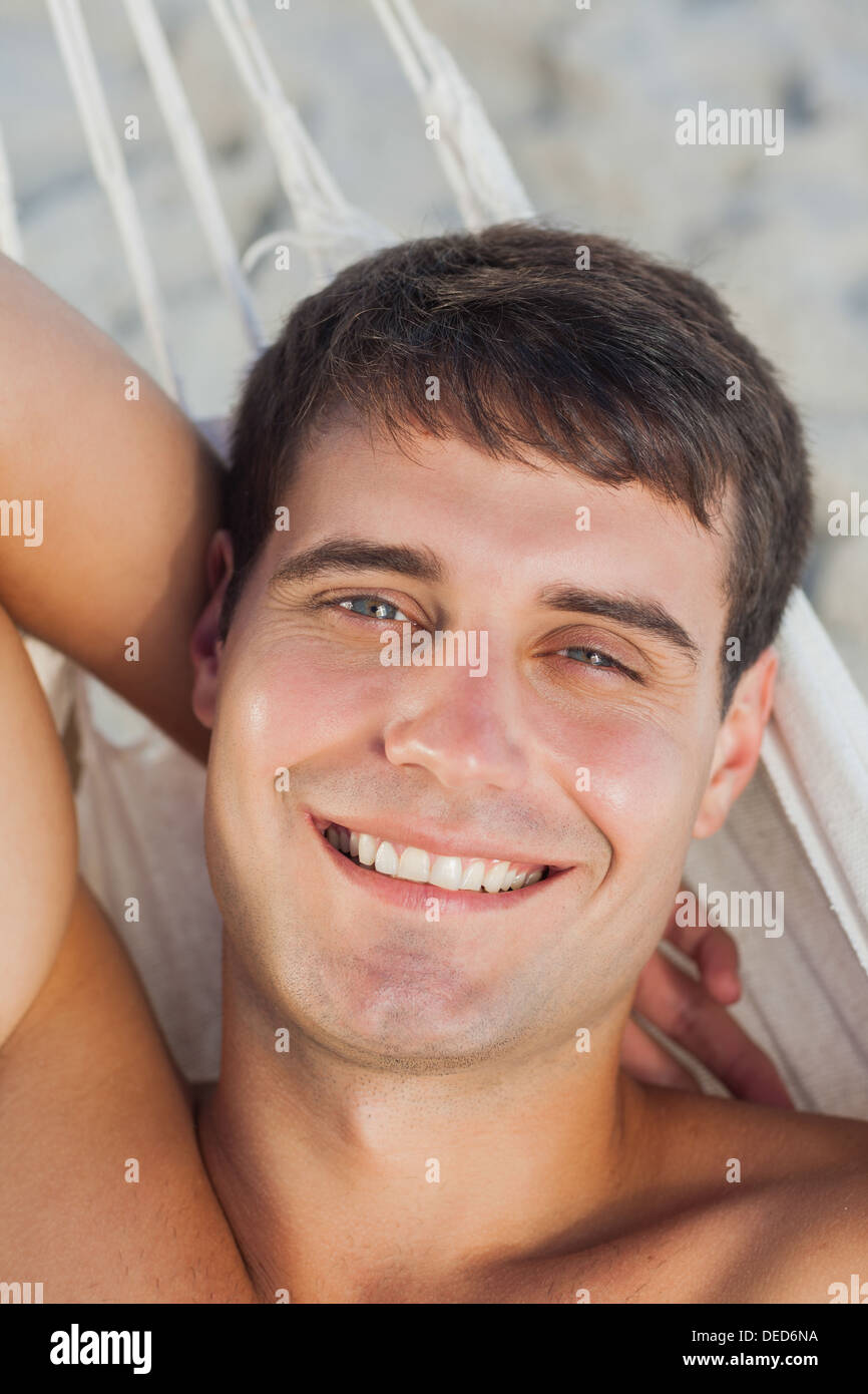 Attractive man lying in hammock Stock Photo