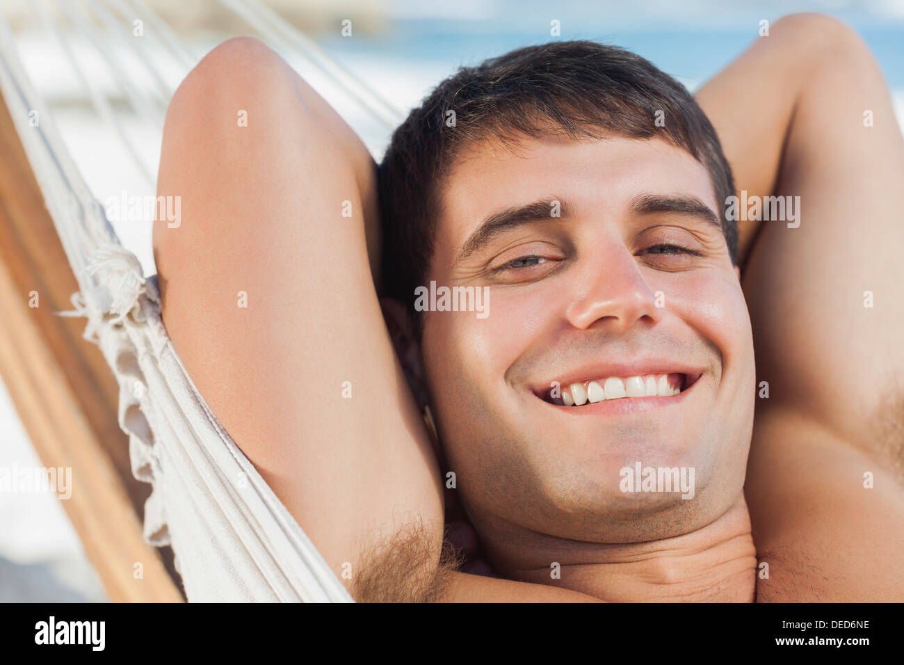 Smiling man relaxing in hammock Stock Photo
