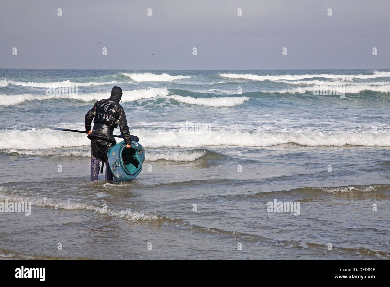 A kayaker prepares to ride the surf on the Oregon Coast, Oregon coast