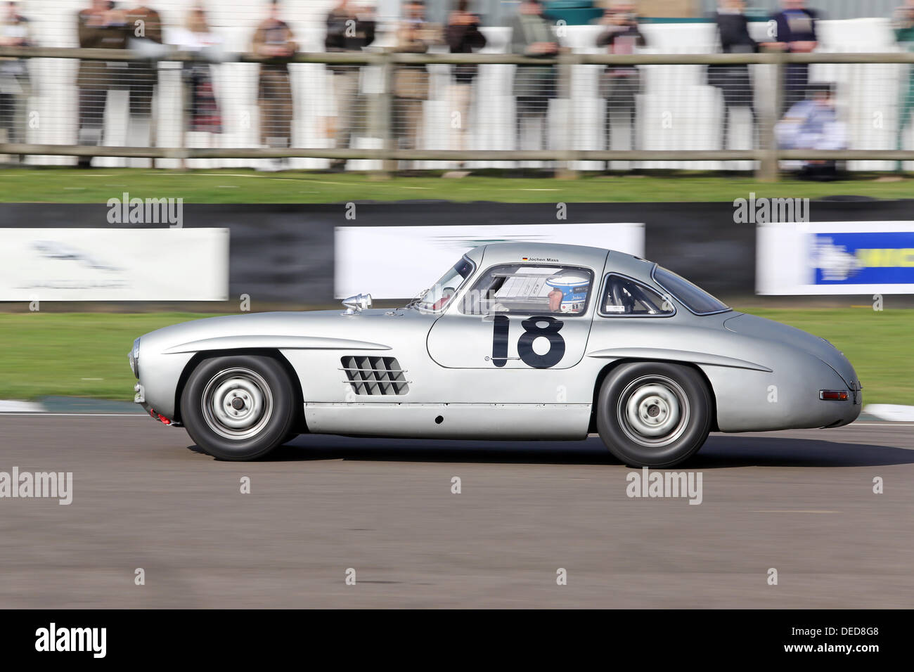 A Silver Grey Mercedesbenz 300sl Gullwing Racing On The Tracks