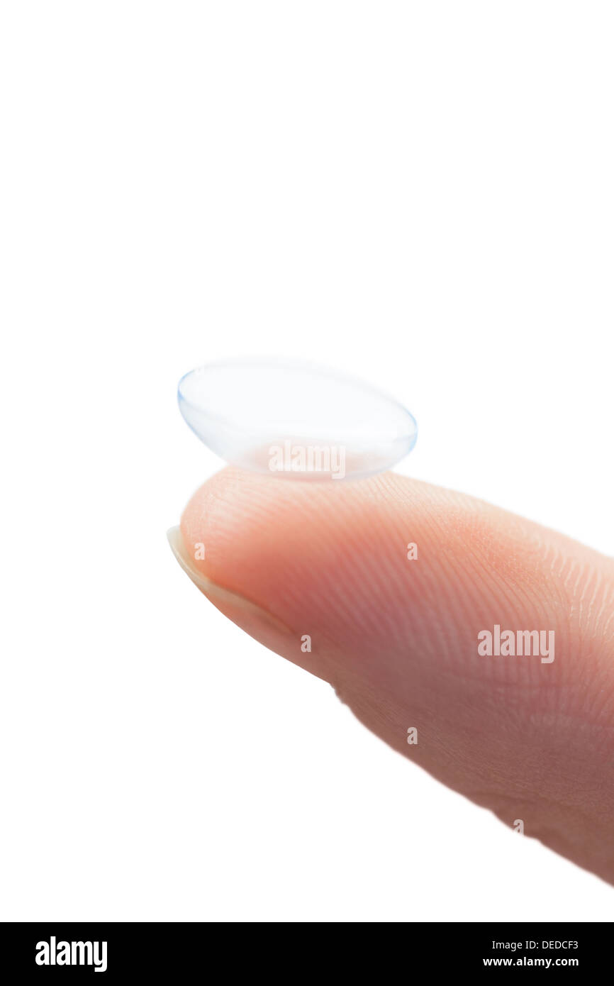 Extreme close up on finger holding contact lens Stock Photo