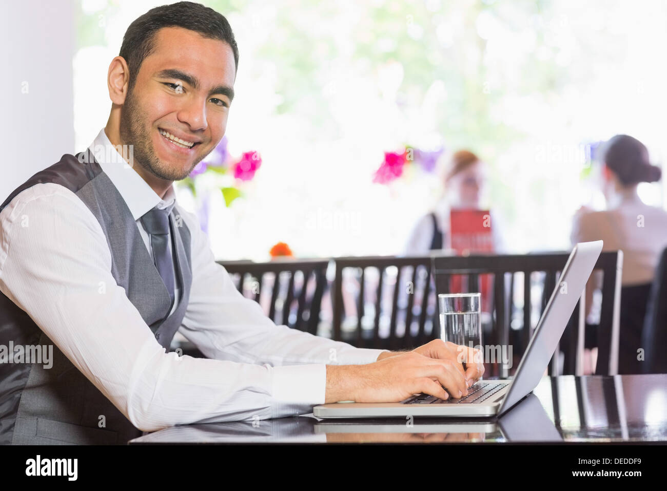 Smiling businessman working on laptop Stock Photo