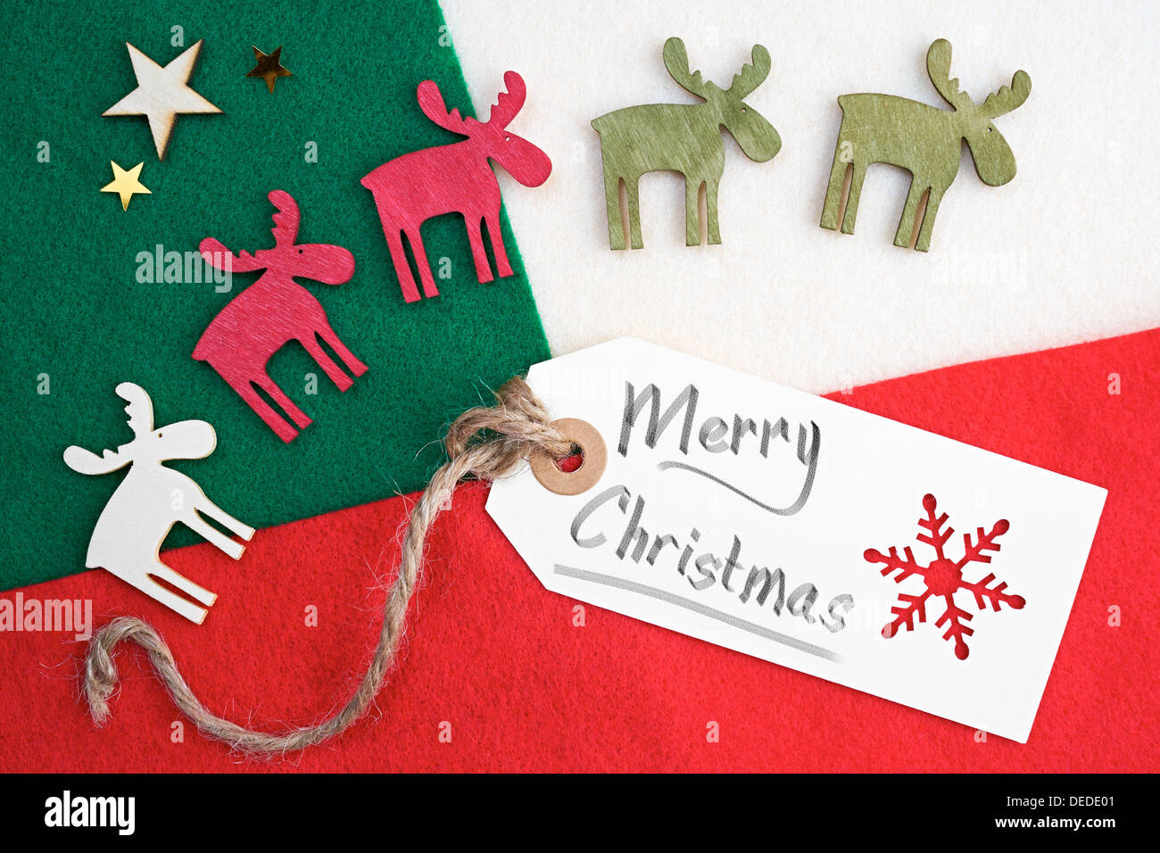 Christmas gift tag on a red, Green and cream felt material background. Stock Photo