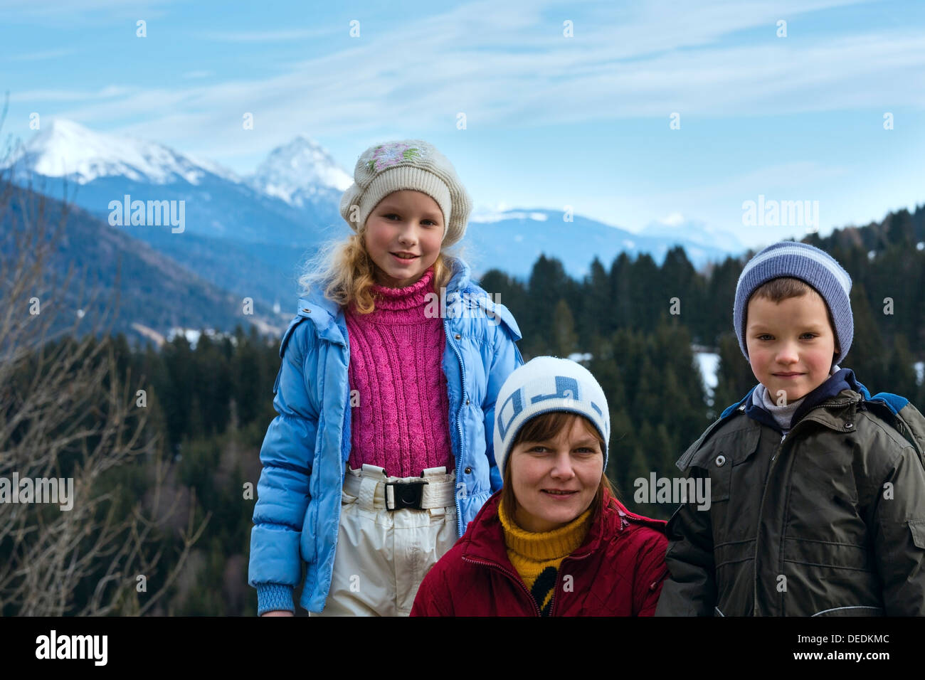 Family on winter mountain background. View from Obergail village outskirts in Lesachtal (Austria). Stock Photo