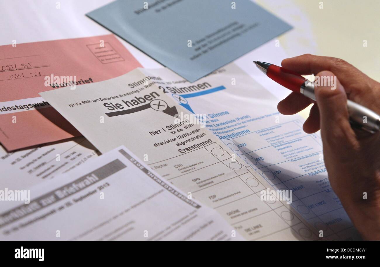 ILLUSTRATION - An illustrated picture shows a hand holding a pen over ballot papers for the German general elections 2013 in Kaufbeuren, Germany, 17 September 2013. Photo: KARL-JOSEF HILDENBRAND Stock Photo