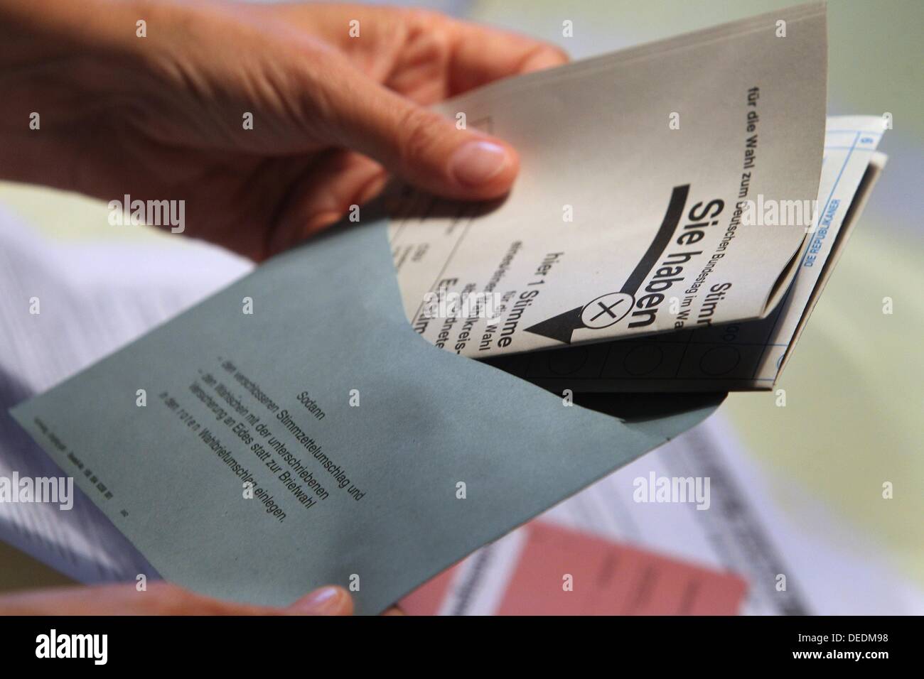 ILLUSTRATION - An illustrated picture shows a hand putting ballot papers for the German general elections 2013 in an envelope in Kaufbeuren, Germany, 17 September 2013. Photo: KARL-JOSEF HILDENBRAND Stock Photo