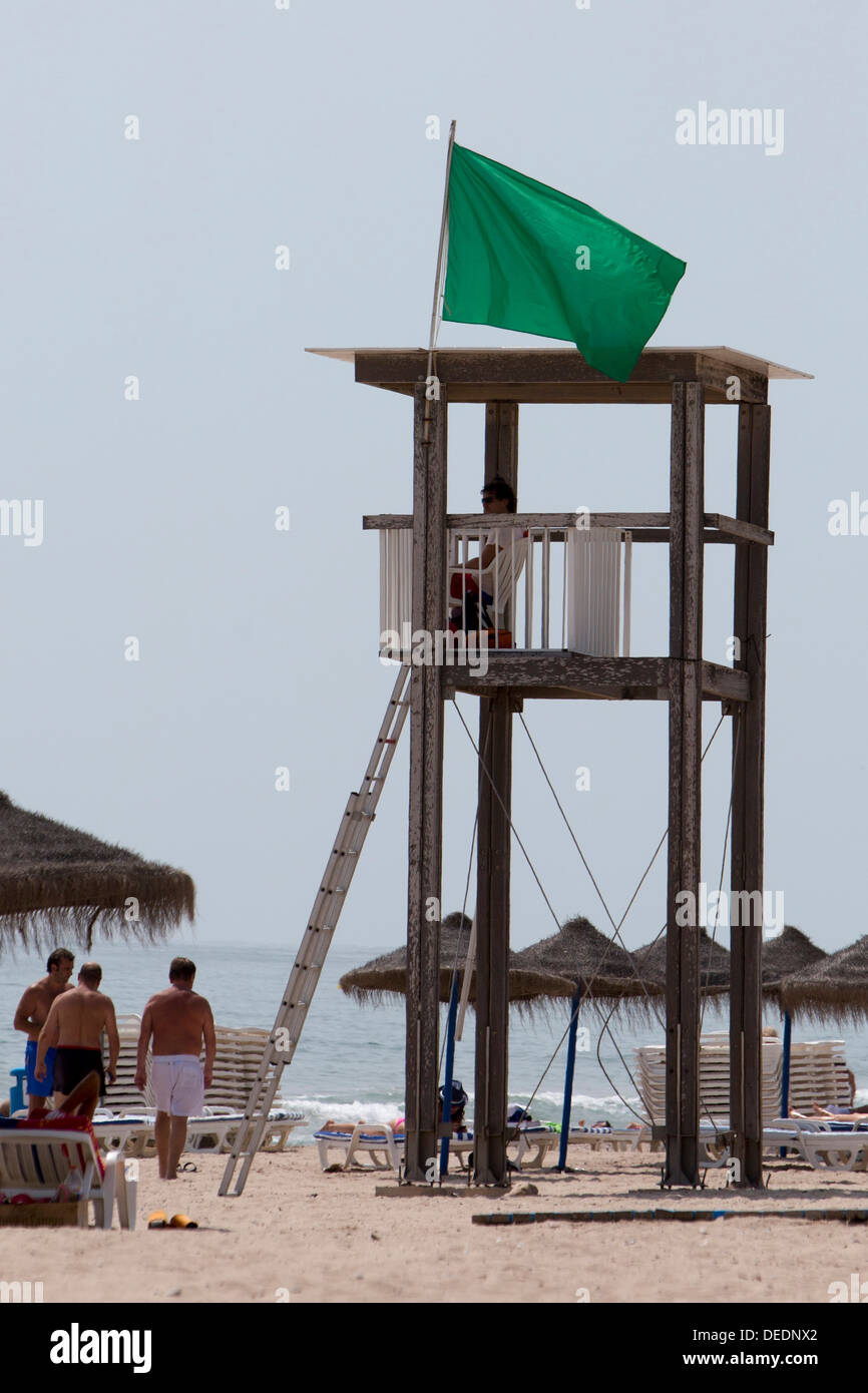Green flag on the beach of El Saler, Valencia Stock Photo