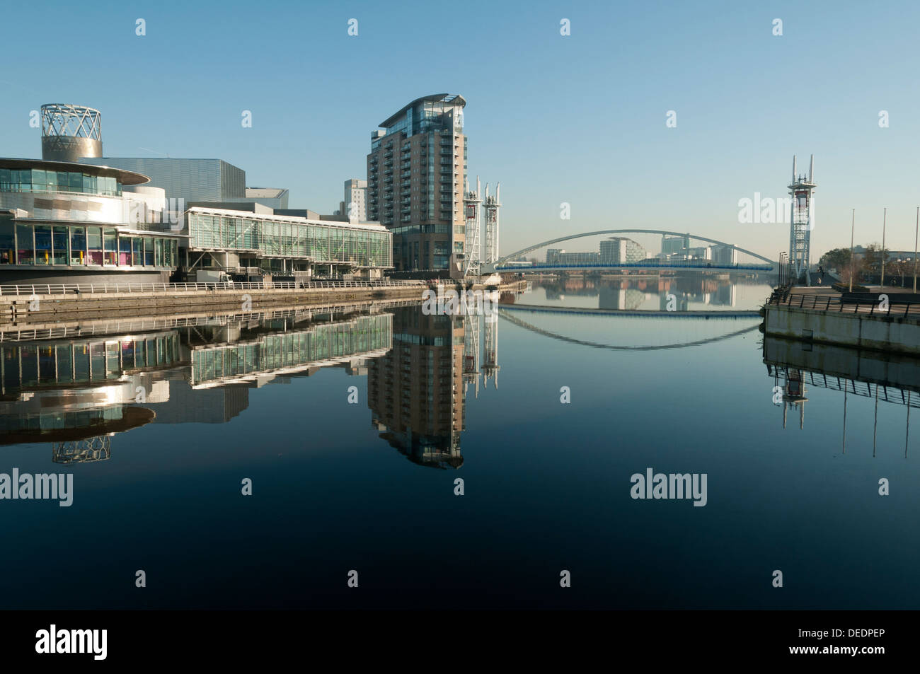 The Lowry, Imperial Point, Millennium footbridge, reflected in the Manchester Ship Canal, Salford Quays, Manchester, England, UK Stock Photo