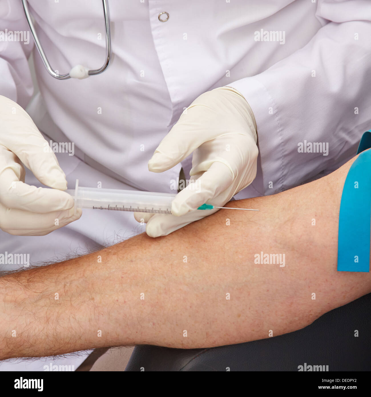 Blut withdrawal on arm with syringe during a blood donation in a hospital Stock Photo