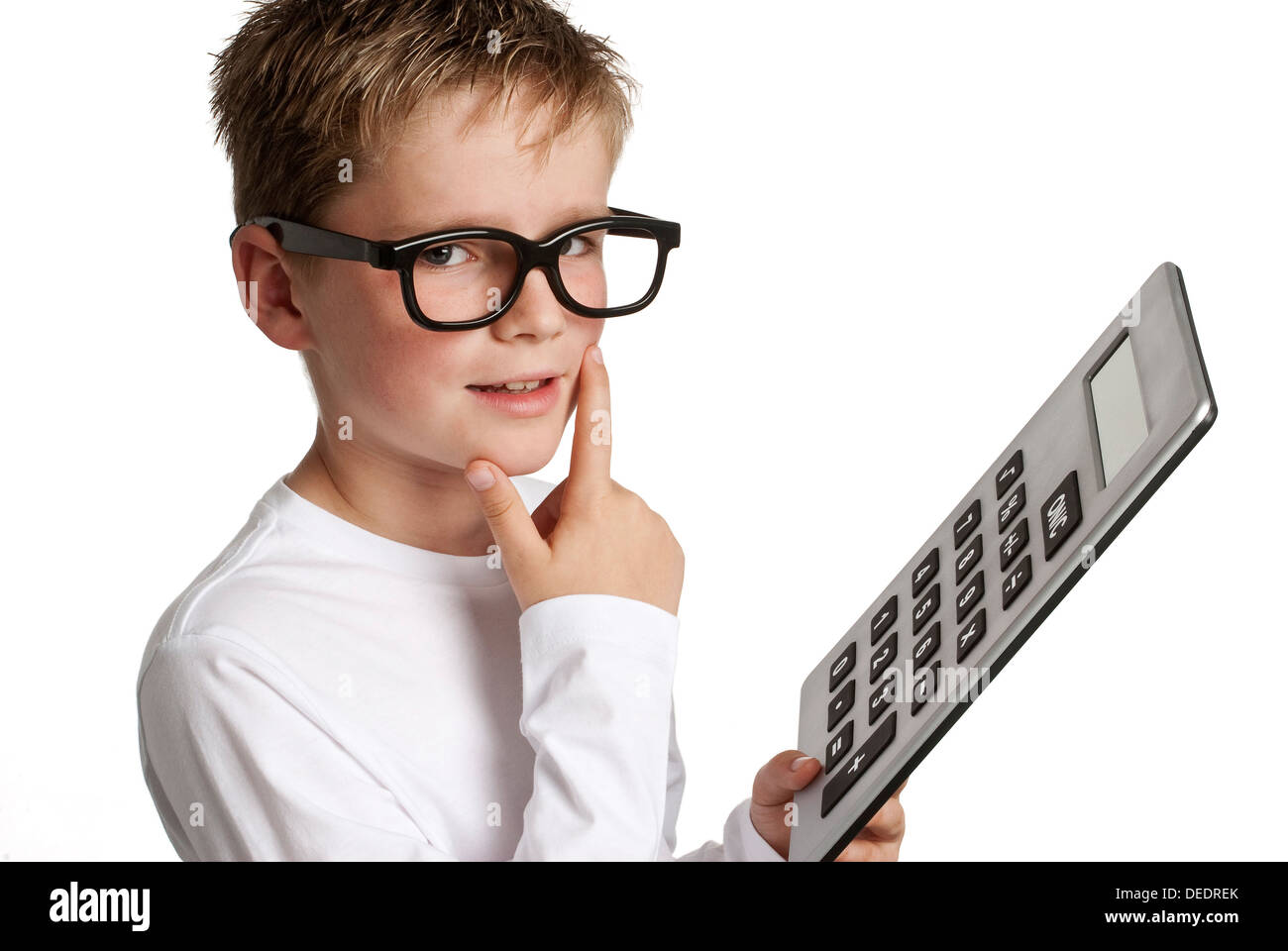 Clever looking boy with caculator. Shot in studio on white background. Stock Photo