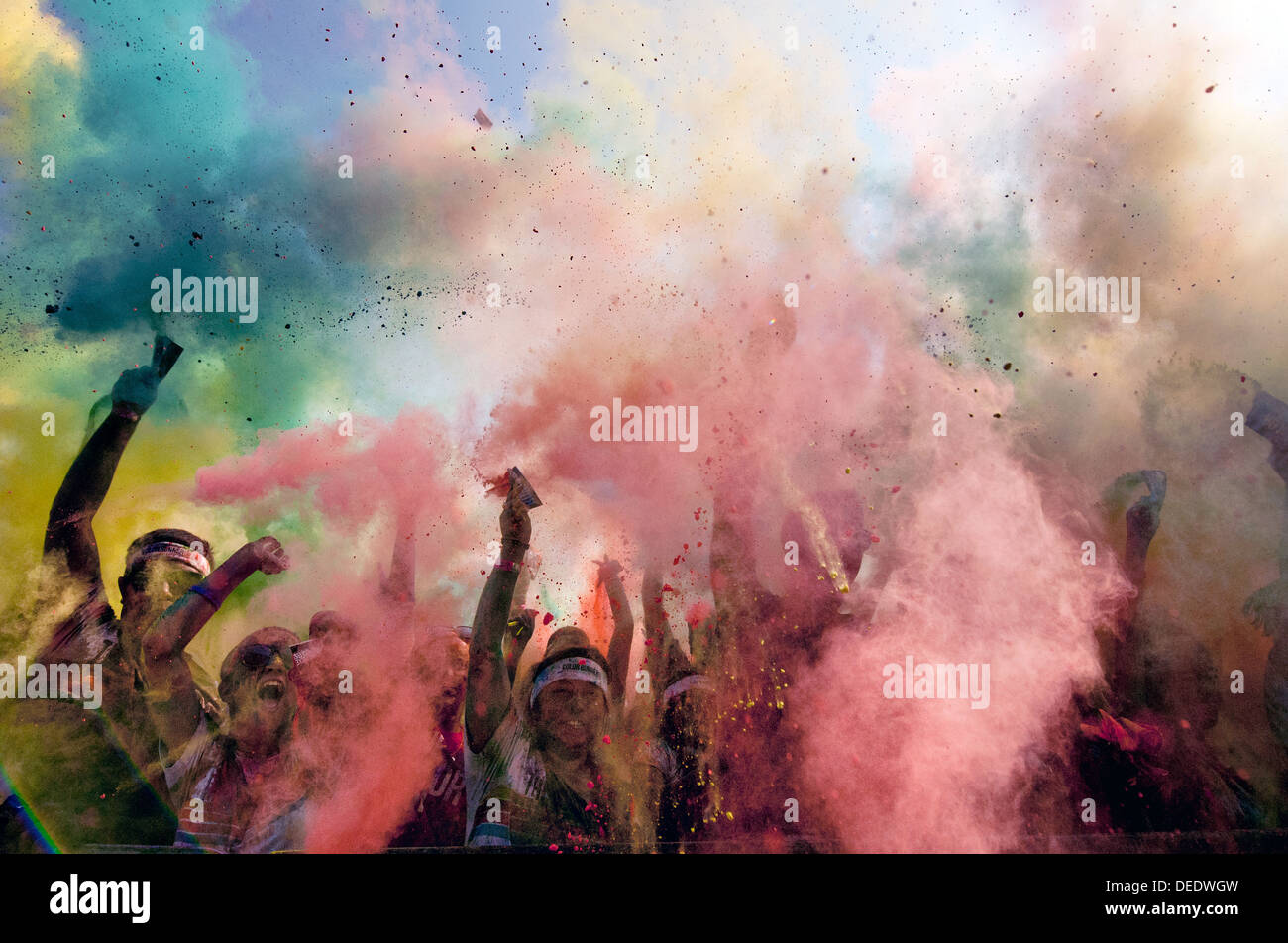 Runners are sprayed with colored powder during The Color Run September 7, 2013 in Wichita Falls, Texas. The Color Run is a fun 5K race where participants are sprayed with colorful powders. Stock Photo