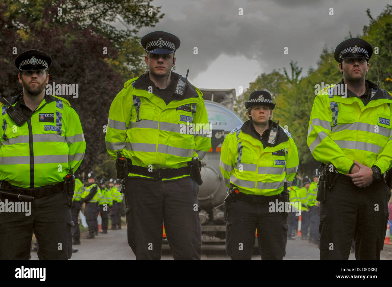 Balcombe, West Sussex, UK. 16th Sept, 2013. Cuadrilla tanker leaves the site surrounded by Police Officers who now outnumber protesters. Protesters lately have not seen to be disrupting Police in their duties and the atmosphere has been very relaxed and amicable.  Environmentalist rejoiced after todays failed attempt by West Sussex County  in the high court, due flawed case, to evict them from the road side camp. © David Burr/Alamy Live News Stock Photo