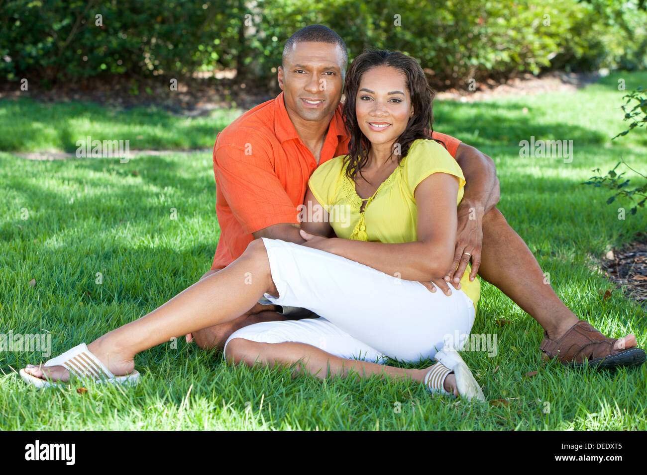 A young African American woman & man couple outside in the summer Stock Photo
