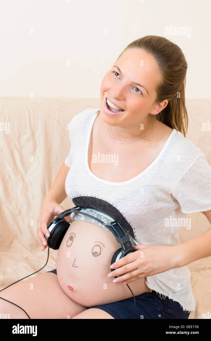 Pregnant Woman Playing Music To Her Baby With Headphones On Belly Stock  Photo, Picture and Royalty Free Image. Image 116985232.