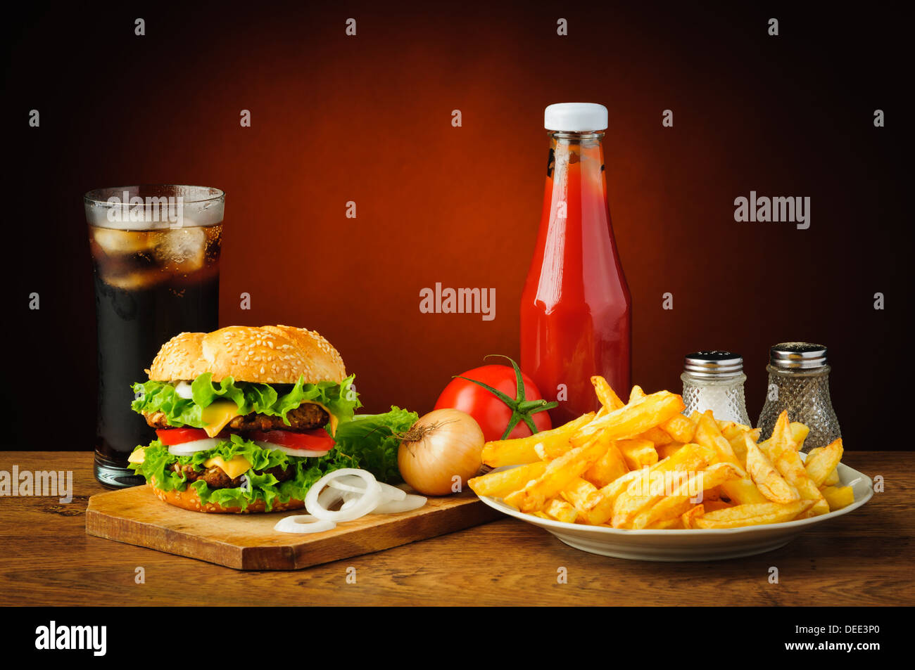 still life with hamburger menu, french fries, cola drink, tomato ketchup, salt and pepper Stock Photo