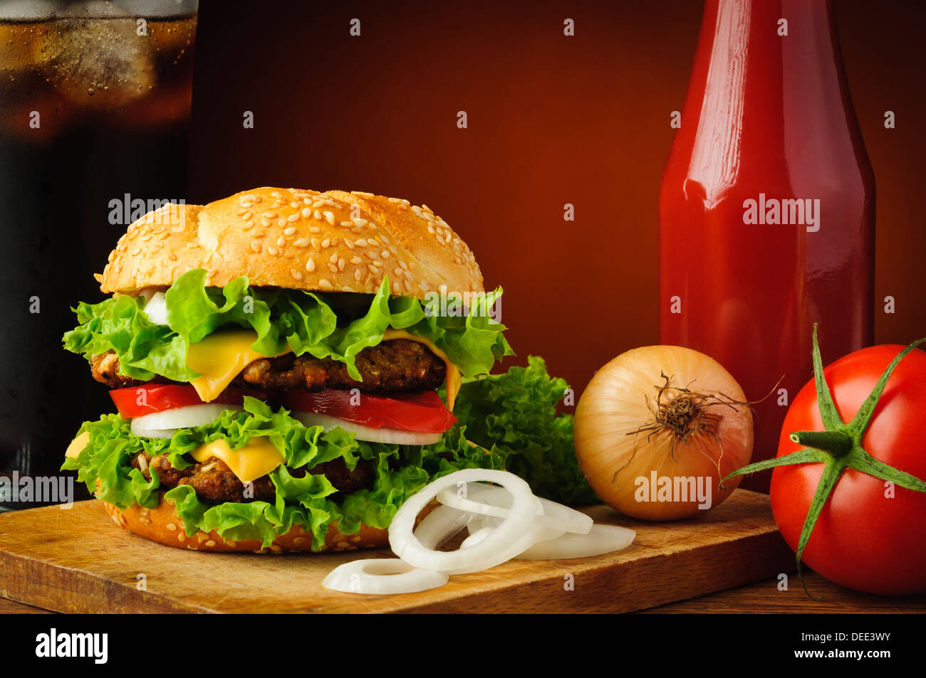 still life with cheeseburger and vegetable ingredients Stock Photo