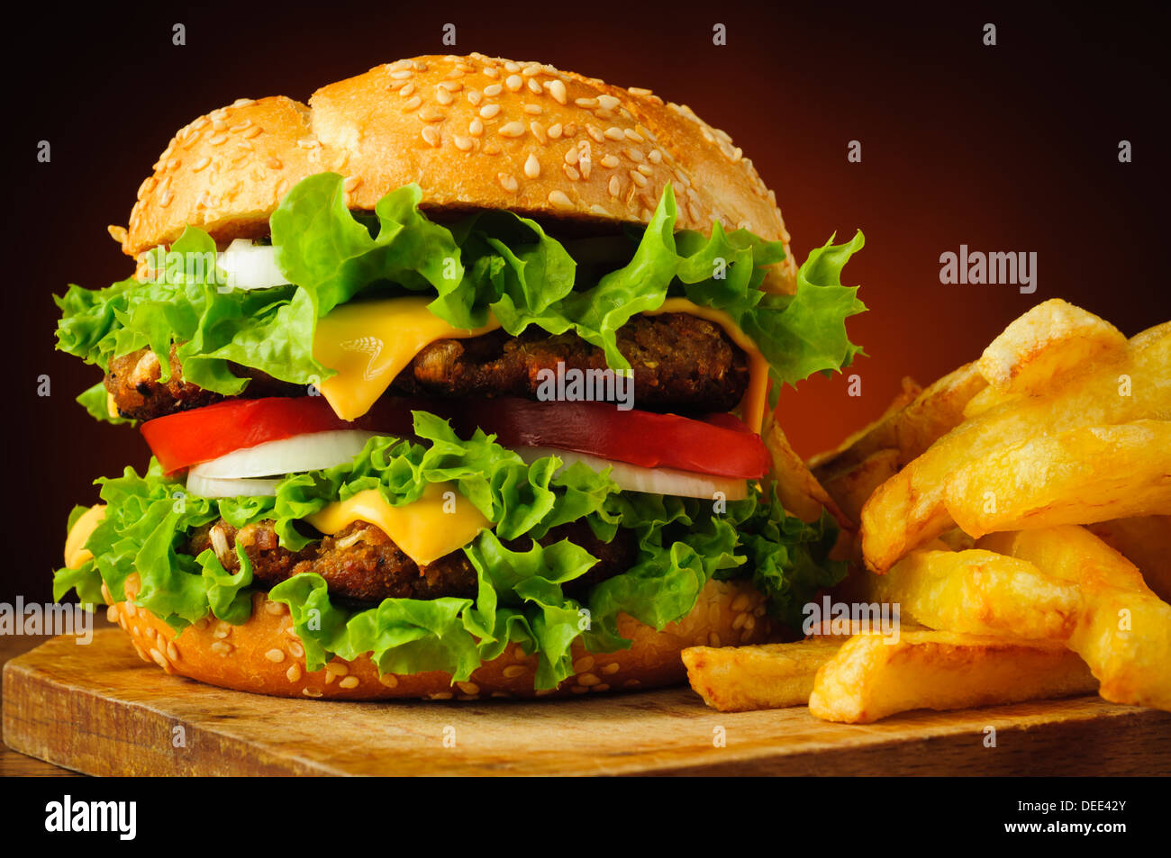 closeup of traditional cheeseburger or hamburger and frech fries Stock Photo