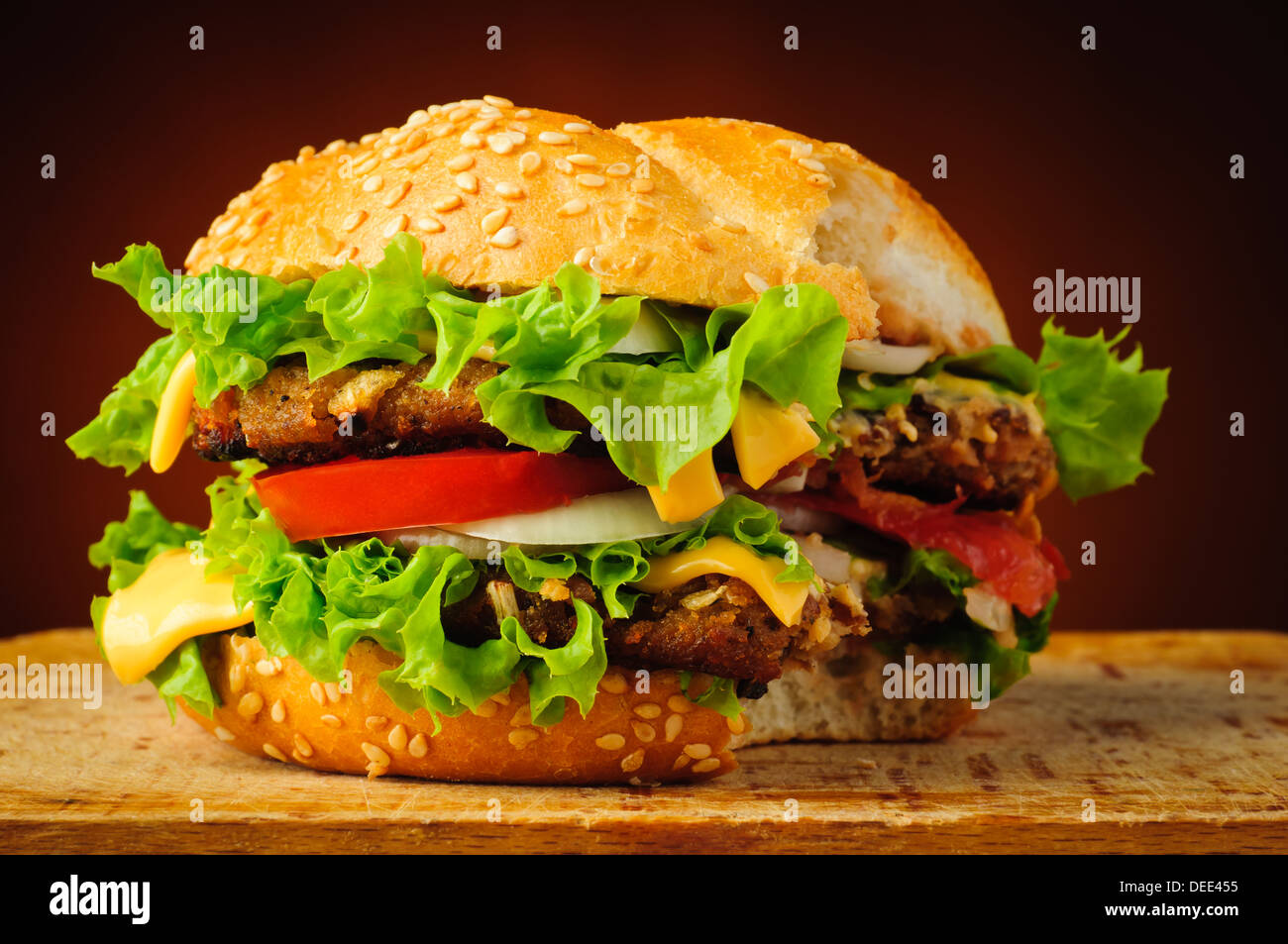fast food with big delicious bitten hamburger or cheeseburger Stock Photo