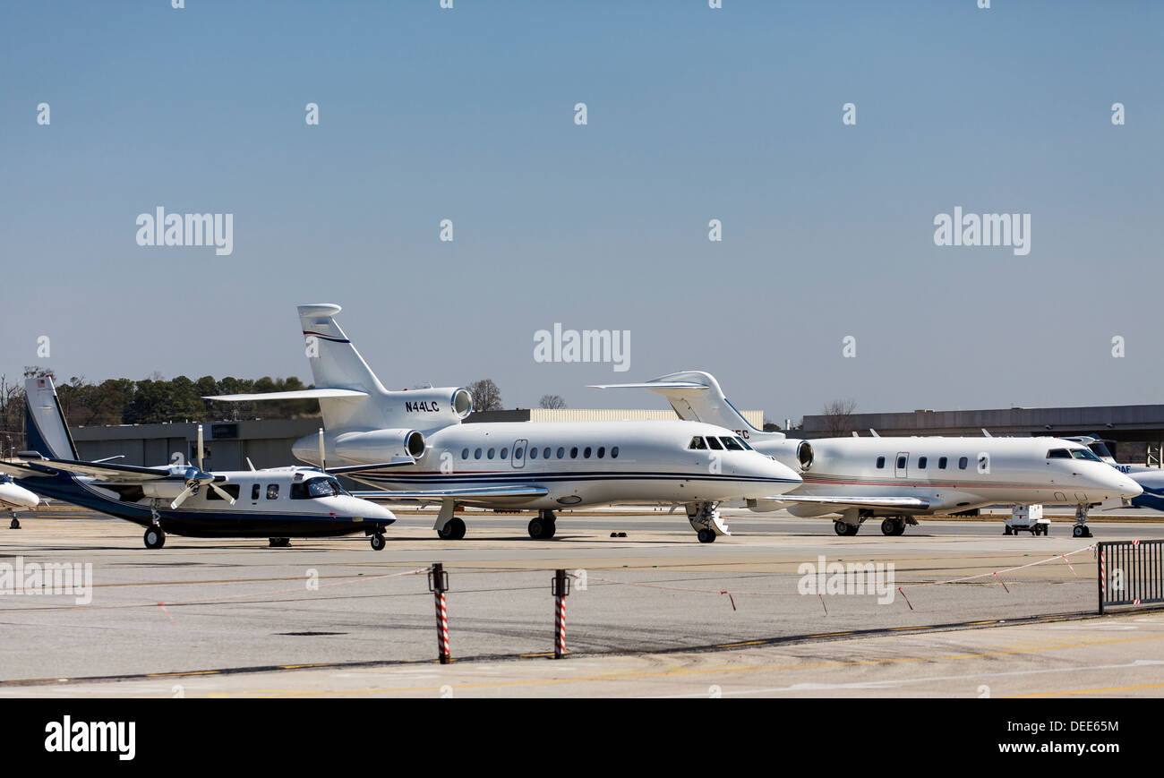 A Falxon 900EX turbo jet on the tarmac with other planes Stock Photo