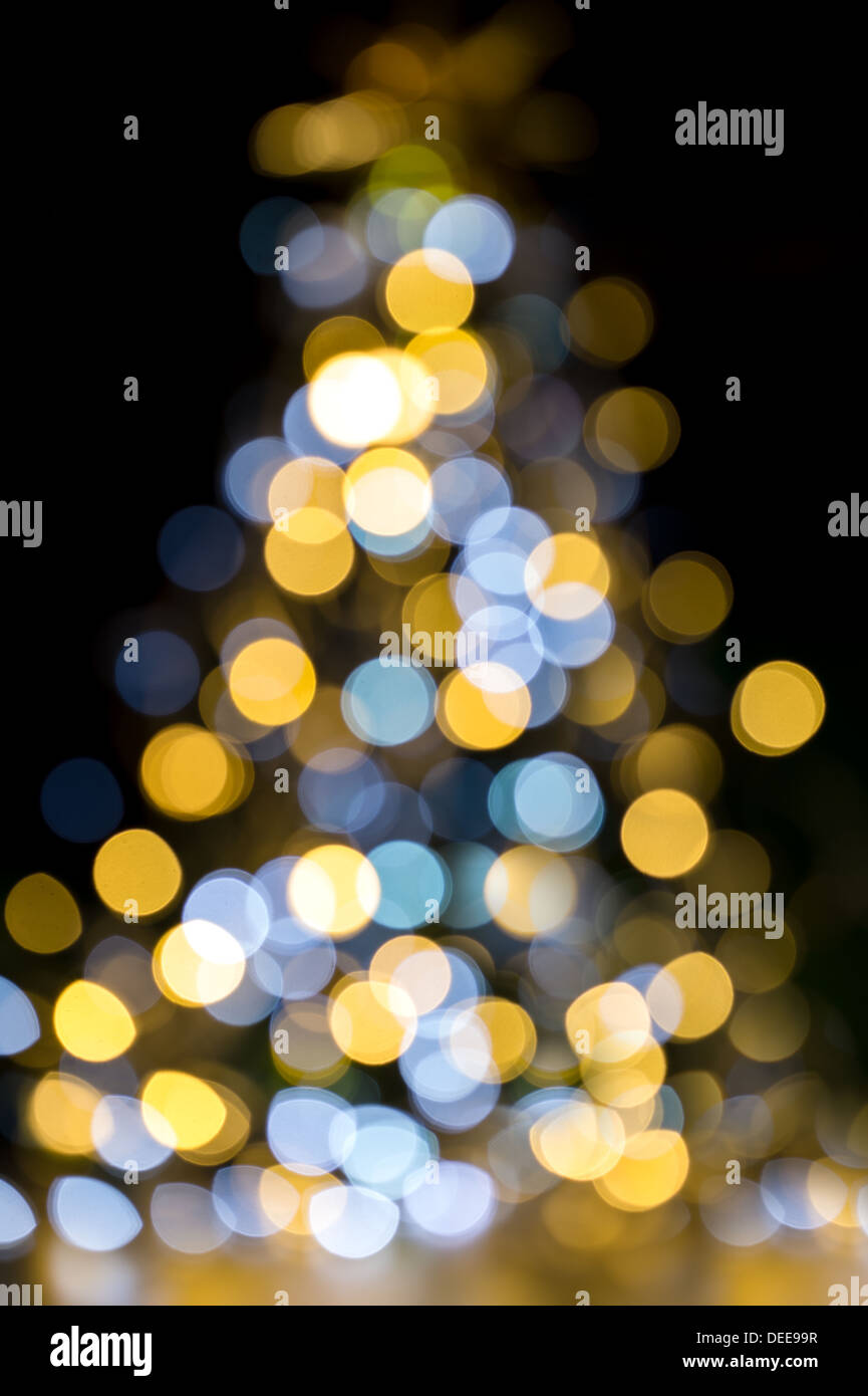 Golden and blue Christmas lights illuminated Background tree Stock Photo