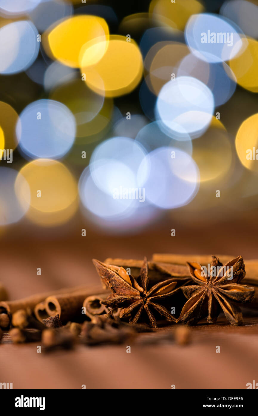 Christmas spices clove, star anise and cinnamon sparkling lights background Stock Photo